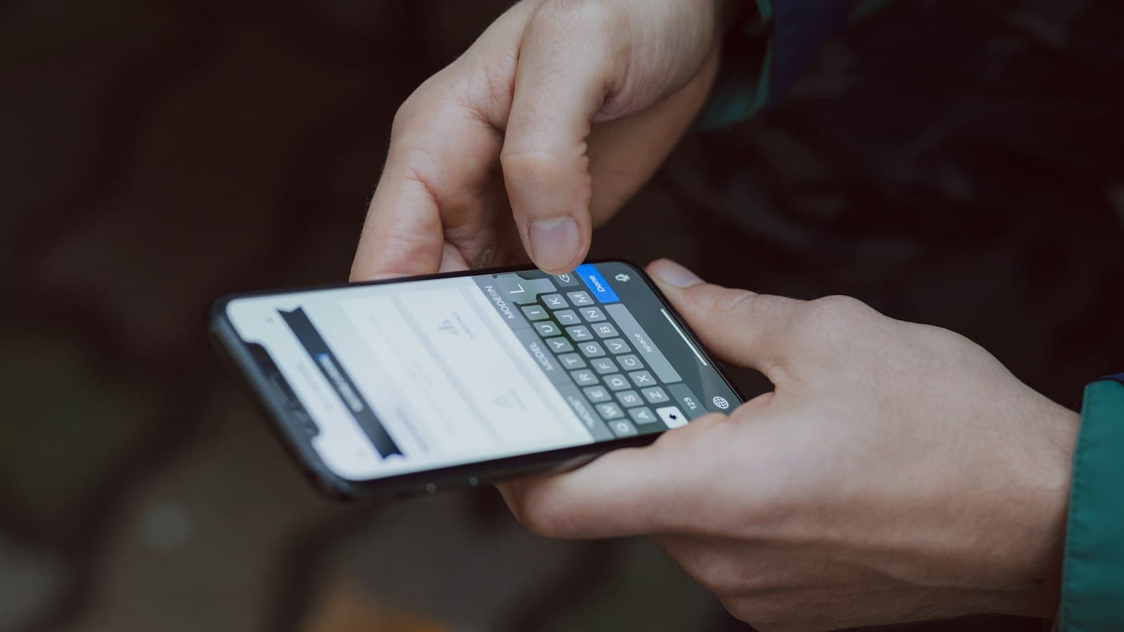 Mãos digitando uma mensagem no celular